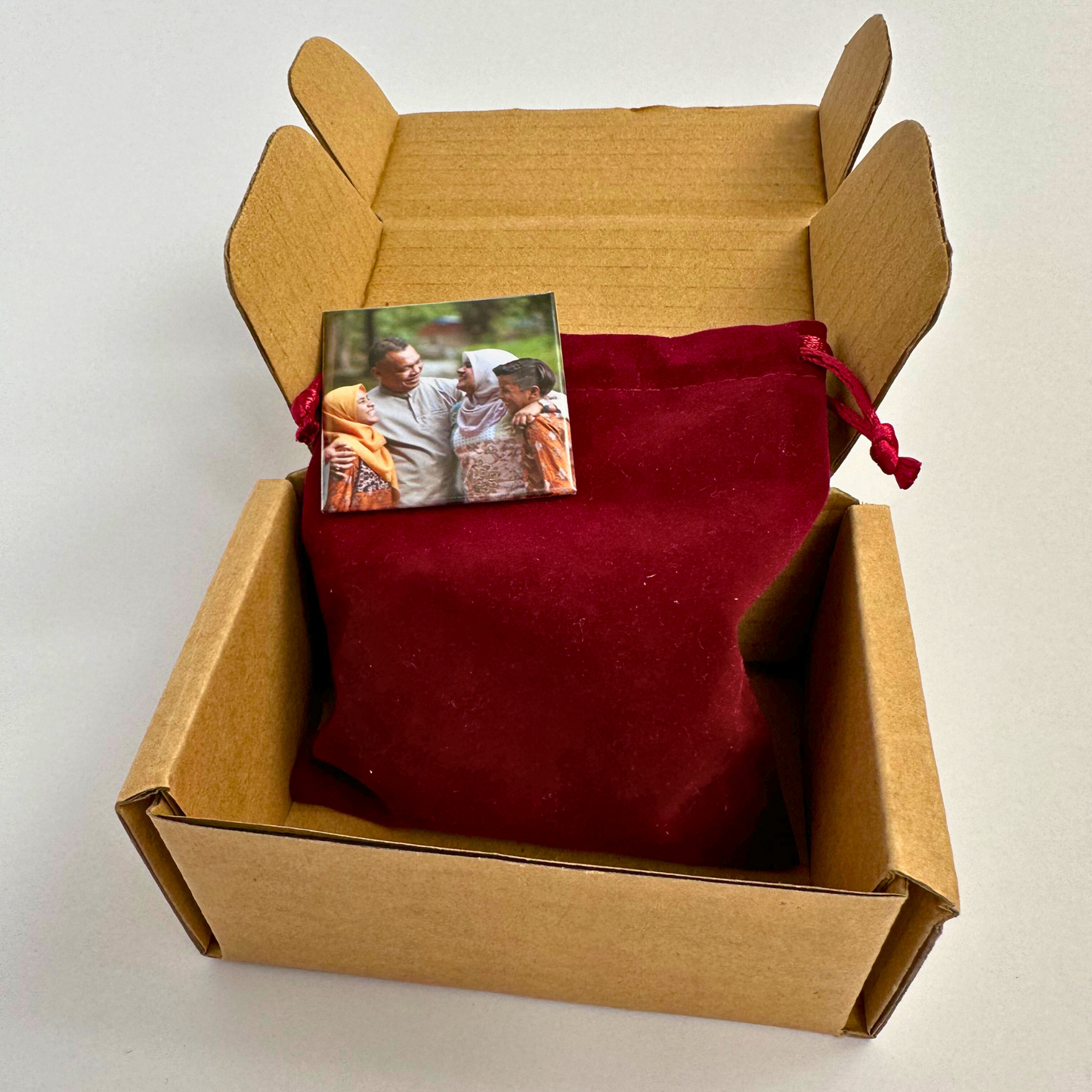 Custom photo magnet with pouch in delivery box – Ready to gift or display.